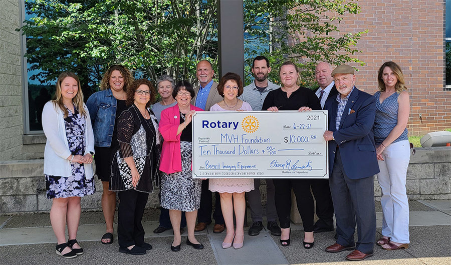 Area Rotary groups pose with MVHR staff and donation check
