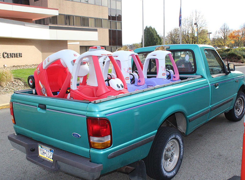 toy trucks loaded on the back of pickup trucks