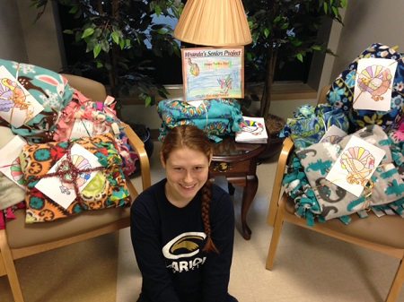 Miranda is pictured with the 22 homemade blankets.