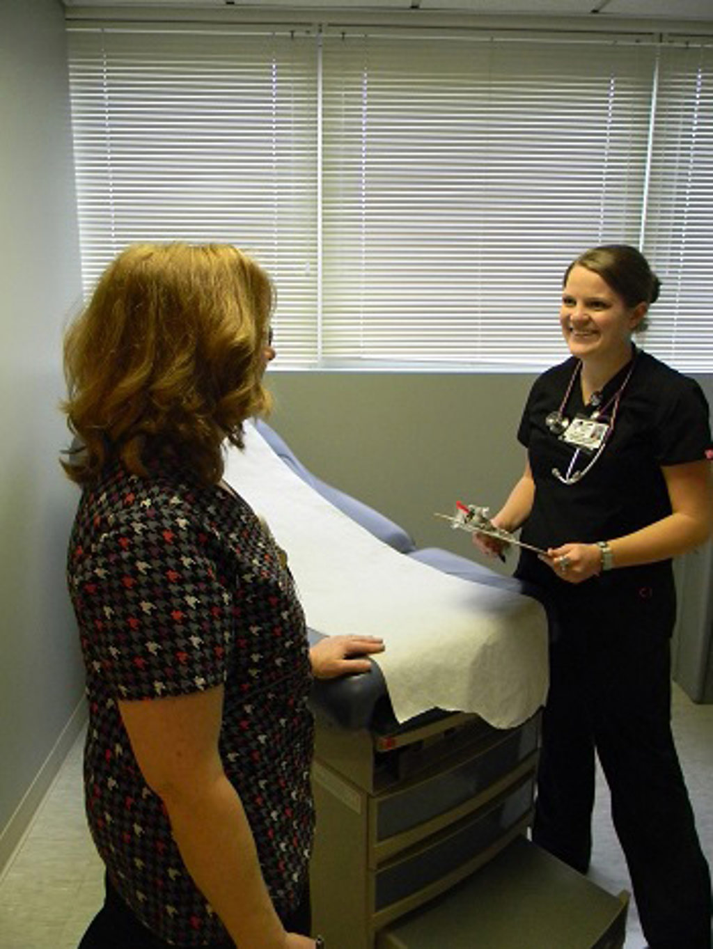 Shelby Davison, PA-C sees a patient in one of the new rooms at QCare, St. Marys.